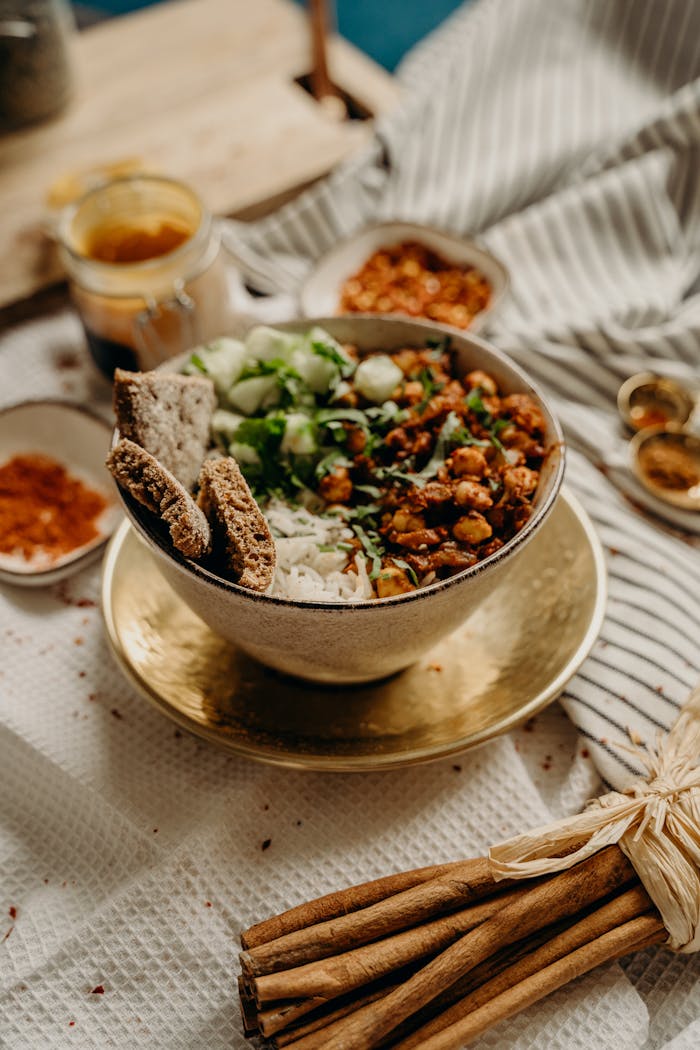 A delicious, healthy vegan bowl featuring chickpeas, rice, cucumbers, and spices. Perfect for a nutritious meal.